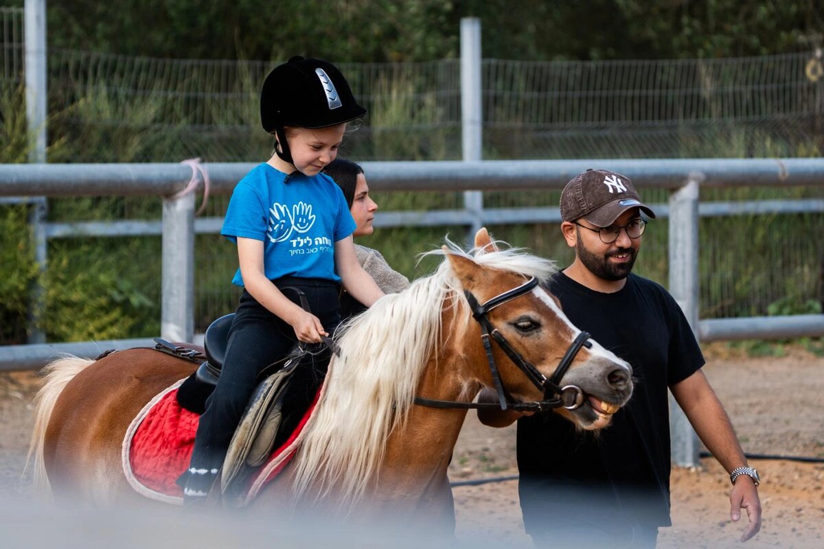 Children connecting with horses at Aviv Farm — Yes Day program